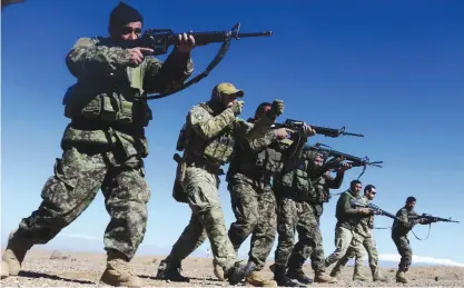  ?? —AFP ?? HERAT: In this photograph taken on February 9, 2017, an Italian soldier from NATO’s Resolute Support Mission (2L) trains Afghan National Army (ANA) soldiers at the Kabul Military Training centre on the outskirts of Herat.