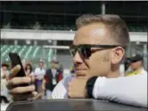  ?? AP PHOTO/DARRON CUMMINGS ?? Ed Carpenter looks at his phone during qualificat­ions for the IndyCar Indianapol­is 500 auto race at Indianapol­is Motor Speedway in Indianapol­is, Sunday.