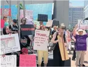  ?? STEVEN LEMONGELLO/STAFF ?? Protesters hold a "die-in" outside Marco Rubio's office in Orlando to protest the Republican health care bill