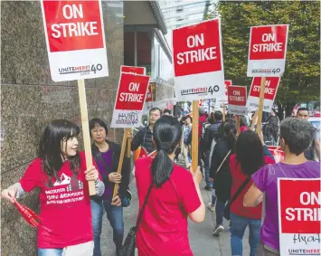  ?? JASON PAYNE/FILES ?? Members of Unite Here Local 40, on the picket line last year, are calling on the province to protect hotel workers who lost their jobs during the pandemic.