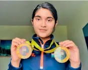  ?? ?? Hyderabad shooter Esha Singh shows off the two gold medals she won at the Internatio­nal Shooting Sport Federation (ISSF) Junior World Cup in Suhl, Germany.