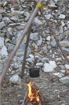  ??  ?? A teepee fire lay is the most commonly used fire for warmth or for boiling directly
above the flame. It can also act as a basis for starting other fire lays. Here, the author used a teepee fire to boil water in a kettle suspended on a large
tripod.