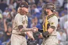  ?? ASSOCIATED PRESS ?? Reliever Josh Hader shakes hands with catcher Austin Nola after getting a four-out save in the Padres’ 5-3 win over the Dodgers in Game 2 of an NDLS on Wednesday.