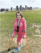  ??  ?? Chloe poses for a photo in front of Stonehenge, which has good accessibil­ity despite being about 5,000 years old.