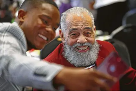  ?? Godofredo A. Vasquez / Houston Chronicle ?? The stern but encouragin­g founder and longtime coach of Texas Southern University’s debate team, Thomas F. Freeman, center, poses for a selfie with Adonis Warren, a current student, while celebratin­g his 99th birthday at the university Saturday.
