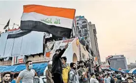  ?? HADI MIZBAN/AP ?? Anti-government protesters gather Friday in Tahrir Square in Baghdad. Celebratio­ns erupted following Prime Minister Adel Abdul-Mahdi’s announceme­nt that he will resign.