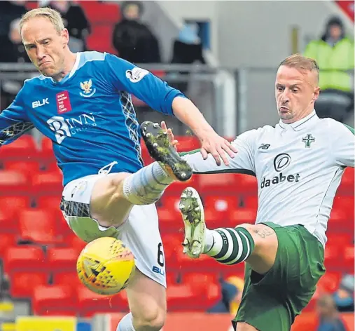  ??  ?? Saints defender Steven Anderson challenges Celtic striker Leigh Griffiths in yesterday’s heavy loss at McDiarmid Park.