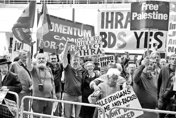  ??  ?? Demonstrat­ors hold placards as they protest outside the headquarte­rs of Britain’s opposition Labour party in central London. — AFP photo