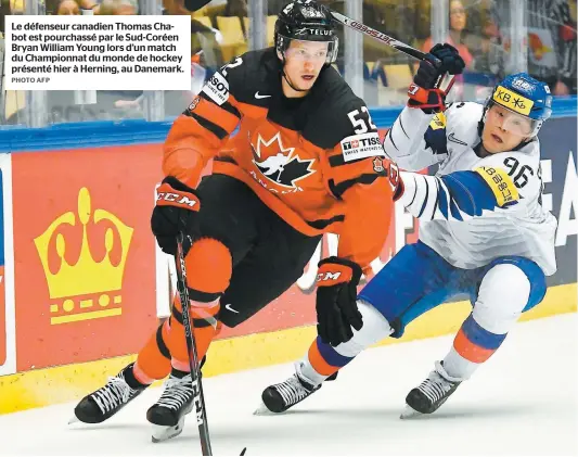  ?? PHOTO AFP ?? Le défenseur canadien Thomas Chabot est pourchassé par le Sud-Coréen Bryan William Young lors d’un match du Championna­t du monde de hockey présenté hier à Herning, au Danemark.