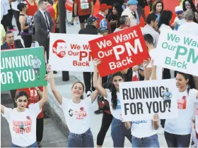  ?? Anwar Amro / AFP / Getty Images ?? Backers of Prime Minister Saad Hariri show their support at Beirut’s annual marathon. Hariri, who is in Saudi Arabia, announced his resignatio­n Nov. 4.