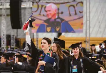  ?? Robert Franklin / South Bend Tribune via AP ?? Graduates walk out of Notre Dame Stadium in protest as Vice President Mike Pence speaks during the 2017 commenceme­nt ceremony Sunday in South Bend, Ind. They were some of dozens who left during the specch.