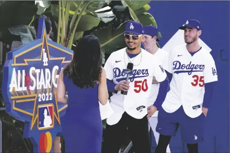  ?? MARK J. TERRILL/AP ?? Los Angeles Dodgers’ Mookie Betts, second from left, speaks with Alanna Rizzo (left) of the MLB Network as Walker Buehler (second from right) and Cody Bellinger look on during an event to officially launch the countdown to MLB All-Star Week on Tuesday at Dodger Stadium in Los Angeles. The All-Star Game is scheduled to be played on July 19.