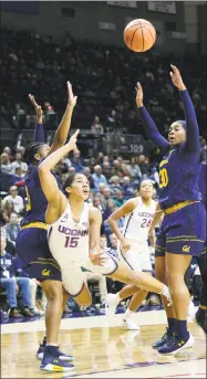  ?? Stephen Dunn / Associated Press ?? UConn’s Gabby Williams (15) goes airborne after being fouled during the first half Friday in Storrs.