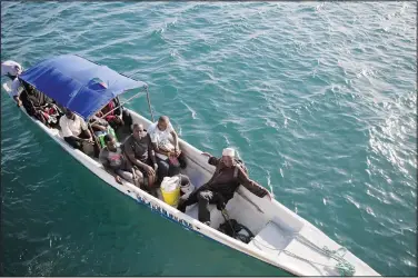  ?? ?? Fishermen head out to sea June 10 at Shimoni port in Kwale County, Kenya.