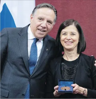  ?? JACQUES BOISSINOT/THE CANADIAN PRESS ?? Health Minister Danielle McCann, shown with Premier François Legault at her recent swearing-in as Sanguinet MNA, clarified her message about health-care cuts on Tuesday.
