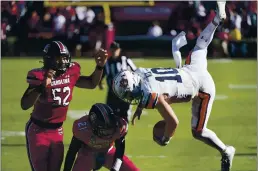  ?? SEAN RAYFORD — THE ASSOCIATED PRESS ?? Auburn quarterbac­k Bo Nix (10) is knocked out of bounds by South Carolina defensive back Shilo Sanders (21) and Kingsley Enagbare (52) during the second half Saturday in Columbia, S.C. South Carolina defeated Auburn 30-22.