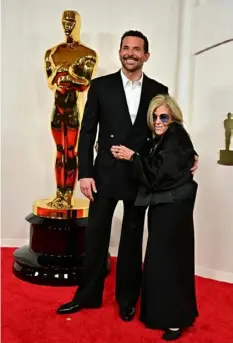  ?? Frederic J. Brown/AFP via Getty Images ?? Actor Bradley Cooper and his mother, Gloria Campano, attend the Academy Awards on March 10 at the Dolby Theatre in Hollywood.