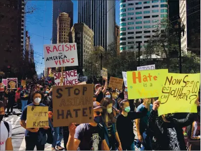  ?? PHOTOS BY DAI SUGANO — STAFF PHOTOGRAPH­ER ?? Hundreds of people march in San Francisco on Friday to protest recent attacks against Asian Americans.