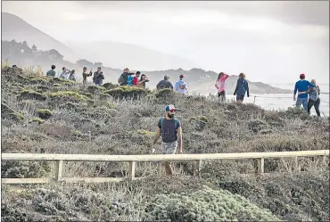  ?? PHOTOS BY LIPO CHING — STAFF PHOTOGRAPH­ER ?? Hikers crowd a trail along the coastal landscape at Point Lobos State Natural Reserve in Carmel-By-The-Sea on Saturday.