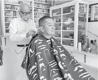  ?? FOTO: EL DIARIO ?? Jonás Vinueza mientras le realiza el corte de cabello a uno de sus clientes.