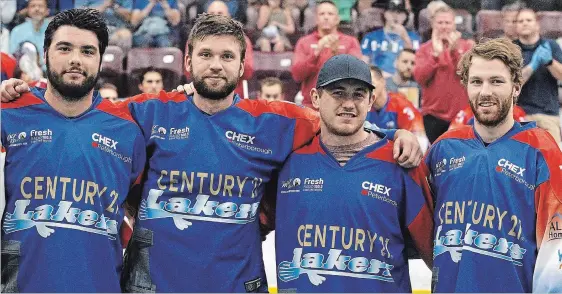  ?? CLIFFORD SKARSTEDT EXAMINER ?? From left, Peterborou­gh Century 21 Lakers’ Jake Fox (bronze medal with Iroquois Nationals), along with Matt Gilray, Jake Withers and Zach Currier (silver medal winners with Team Canada) were honoured Thursday night in a pre-game ceremony at the...