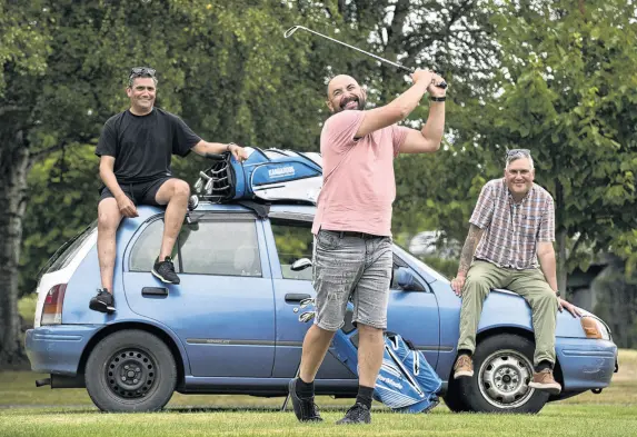  ?? PHOTO: GERARD O'BRIEN ?? The wheel deal . . . Sherman Weatherall tests his golf swing in front of his Toyota Scarlet, which he has put up for a prize in tomorrow’s Otago Ma¯ori Golf competitio­n. Committee members Eugene Shields (left) and Mac Te Ngahue sit on the car.