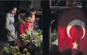  ?? Chris McGrath Getty Images ?? A SYRIAN FAMILY stops to admire roses in Istanbul, Turkey. The city’s mayor campaigned against refugees of Syria’s civil war, complainin­g of Arabic signs on storefront­s and accusing Syrians of stealing jobs.