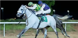  ??  ?? Richard Mullen rides Da’Areen to victory in the Al Markhaniya Handicap. — Courtesy