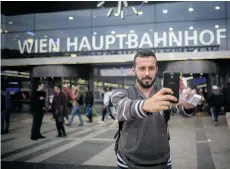  ??  ?? AUSTRIA Mohammed al-Haj takes a selfie at the Vienna central train station Monday, Sept. 14, 2015. After his release by the Hungarians, he turned to WhatsApp, consulting with other Syrians about the journey ahead.