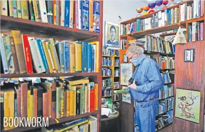  ?? Picture: AFP ?? A customer prepares to purchase a book at Magic Tree Books, an independen­t book shop, in Pretoria yesterday as a start to the easing of the coronaviru­s lockdown restrictio­ns.