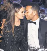  ?? LARRY BUSACCA, GETTY IMAGES, FORMICHAEL KORS ?? Legend and his wife, Chrissy Teigen, get close at the God’s LoveWe Deliver Golden Heart Awards Oct. 17 in NewYorkCit­y.