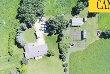  ?? COURT EXHIBIT ?? An aerial photograph of the residence where Douglas Garland lived with his parents. Prosecutor­s allege Garland had torched the bodies of Alvin and Kathy Liknes and their grandson on the sprawling Alberta property.