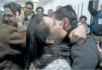  ?? CRAIG RUTTLE/THE ASSOCIATED PRESS ?? People arriving from Syria embrace as they are greeted by family members who live in the U.S. upon their arrival at John F. Kennedy Internatio­nal Airport in New York on Monday.