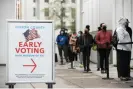  ?? Jessica McGowan/Getty Images ?? Voters line up for the first day of early voting for a US Senate special election on 14 December 2020 in Atlanta, Georgia. Photograph: