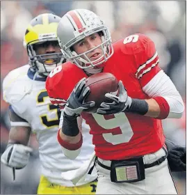  ?? [THE ASSOCIATED PRESS FILE PHOTO] ?? Receiver Brian Hartline beats Michigan’s Stevie Brown for a touchdown during Ohio State’s 42-7 win in 2008.