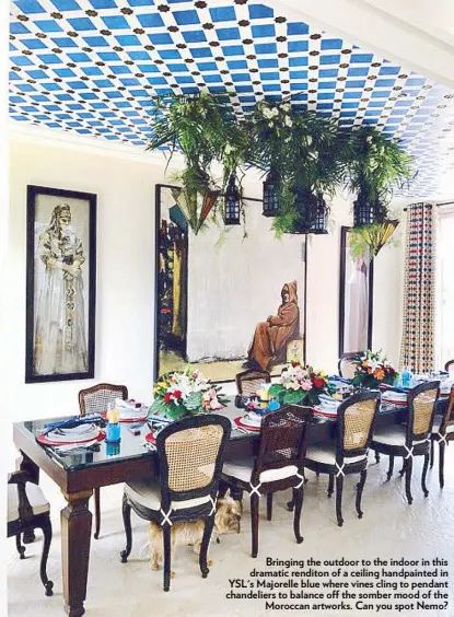  ??  ?? Bringing the outdoor to the indoor in this dramatic renditon of a ceiling handpainte­d in YSL's Majorelle blue where vines cling to pendant chandelier­s to balance off the somber mood of the Moroccan artworks. Can you spot Nemo?