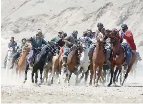  ?? — Reuters ?? Afghan horsemen compete during a Buzkashi game in Panjshir province, north of Kabul.