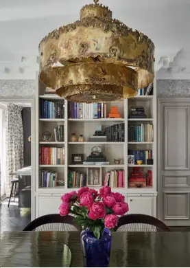  ??  ?? THIS PAGE
Reupholste­red in a playful leopard print fabric, the vintage chairs by the fireplace date to the late 19th century; a gold pendant light by Robert Lemariey is the centrepiec­e of the dining room