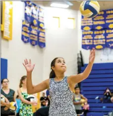  ??  ?? Ana Lynn Flanders, 11, prepares to make a serve while participat­ing in a serving drill Wednesday morning during a free summer camp hosted by Brawley Union High School’s volleyball program at the BUHS gym in Brawley. VINCENT OSUNA PHOTO