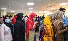  ?? — PTI ?? Indians who were airlifted from Wuhan following the outbreak of the deadly novel cornavirus, stand in a queue to collect release certificat­es before leaving the ITBP quarantine facility at Chhawla, in New Delhi, on Monday. A total of 650 people were brought back from Wuhan in China on Feb. 1-2 in two Air India Boeing 747s.