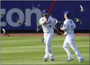  ?? BILL KOSTROUN — THE ASSOCIATED PRESS ?? The Mets’ Juan Lagares, left, and Norichika Aoki celebrate after Monday’s win over the Phillies.