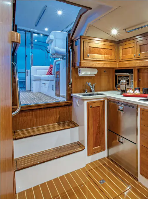  ??  ?? Satin-finish cherry wood warms the 53z’s interior spaces, including the galley. Countertop­s are Corian.