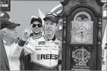  ?? [STEVE HELBER/THE ASSOCIATED PRESS] ?? Brad Keselowski celebrates with the trophy in Victory Lane after winning Sunday’s Cup series race at Martinsvil­le Speedway.