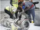  ?? BAY ISMOYO/AFP/GETTY IMAGES ?? Investigat­ors in Jakarta examine engine parts from the Lion Air flight that crashed Oct. 29.