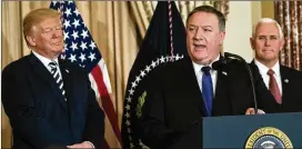  ?? DOUG MILLS / THE NEW YORK TIMES ?? New U.S. Secretary of State Mike Pompeo (center), flanked by President Donald Trump and Vice President Mike Pence, speaks Wednesday during a ceremonial swearing-in at the State Department.