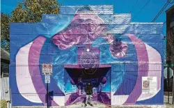  ??  ?? Alex Arzu stands with his “History, a Rose” mural at 1800 Washington.