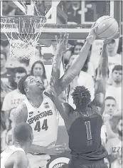  ?? AL GOLDIS — ASSOCIATED PRESS ?? Michigan State’s Nick Ward rejects the shot by Rutgers’ Candido Sa in the first half of the Spartans’ overtime win on Wednesday.