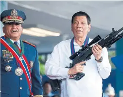  ?? BULLIT MARQUEZ THE ASSOCIATED PRESS FILE PHOTO ?? Philippine President Rodrigo Duterte, right, was democratic­ally elected but has acted like an authoritar­ian, even threatenin­g one senator with arrest.