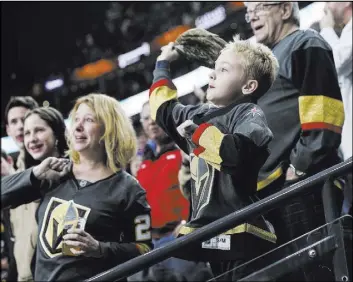  ?? Chase Stevens Las Vegas Review-Journal @csstevensp­hoto ?? Golden Knights fans throw their hats onto the ice in celebratio­n of a hat trick by Jonathan Marchessau­lt during the third period of Vegas’ 7-3 victory over the Pittsburgh Penguins on Saturday at T-Mobile Arena.