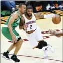  ?? JASON MILLER, GETTY IMAGES ?? Kyrie Irving of the Cavaliers drives against Avery Bradley of the Boston Celtics on Tuesday night in Cleveland.